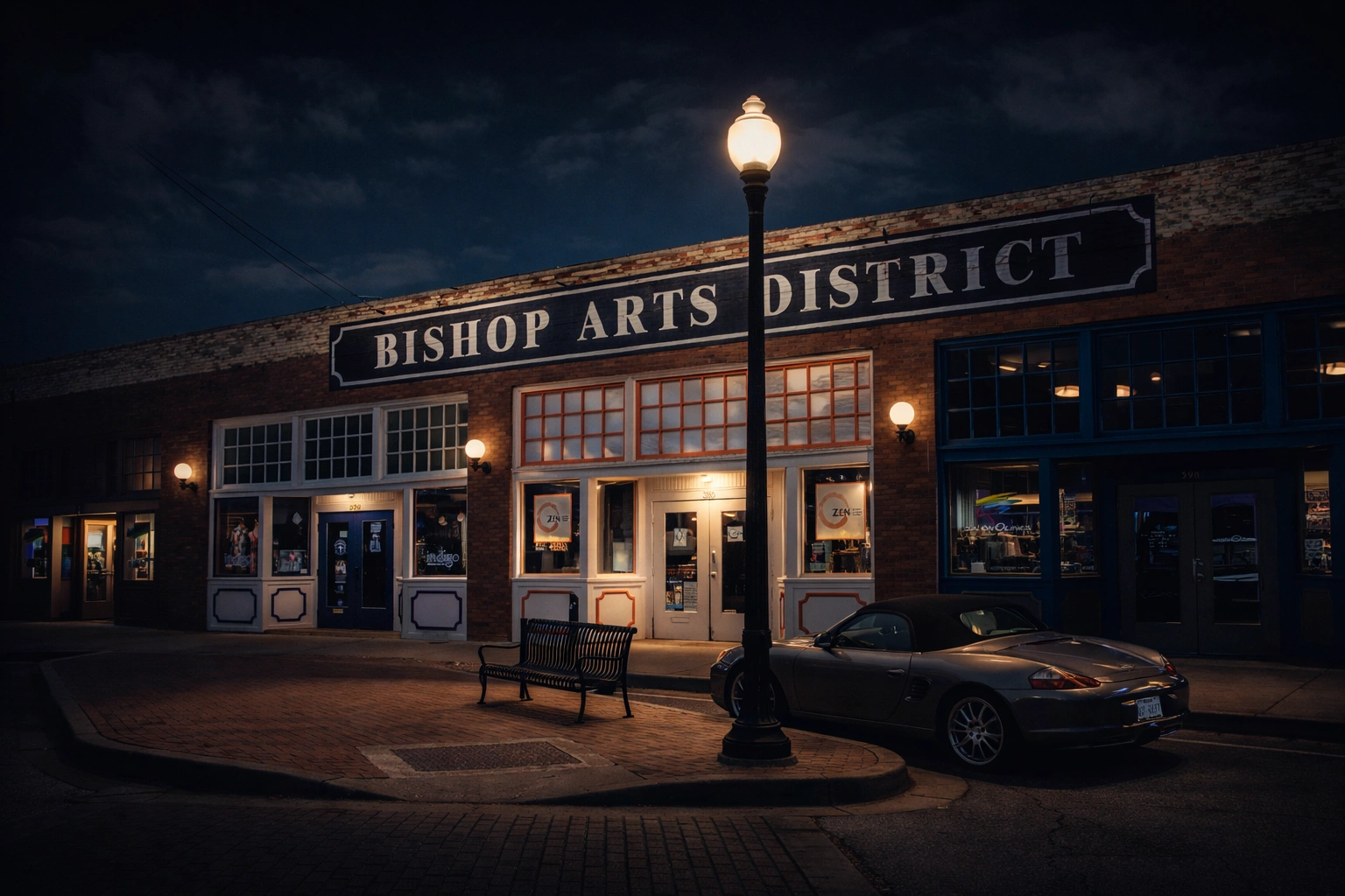 Bishop Arts District sign and storefront at night with vintage street lamp illuminating brick buildings in Oak Cliff Dallas